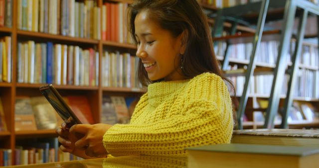 Smiling Woman Using Tablet in Library - Download Free Stock Images Pikwizard.com