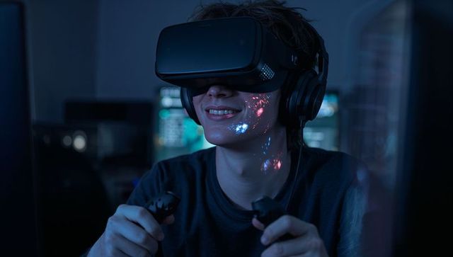 Teen Gamer Wearing VR Headset and Headphones Holding Controllers with Neon Reflections