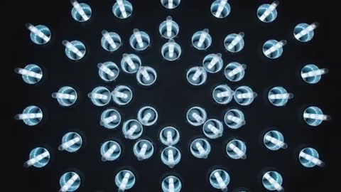 Pulsing Top-Down LED Array Creating Radial Cyan Halos Over Circular Cups and Straws