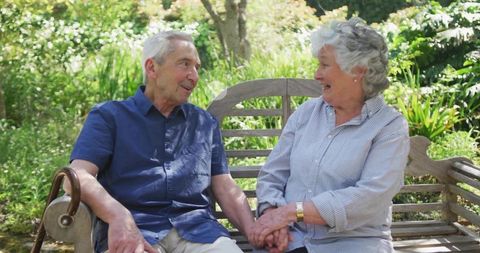 Senior Couple Enjoying Peaceful Park Day on Rustic Wooden Bench