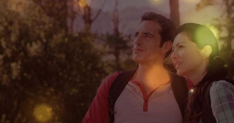 Couple Exploring Scenic Forest Trail with Warm Sunlight Glows