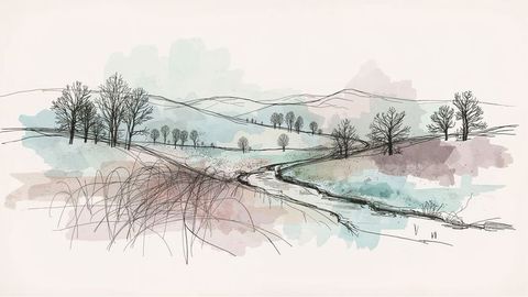 Tranquil winter stream in hilly farmland at dawn