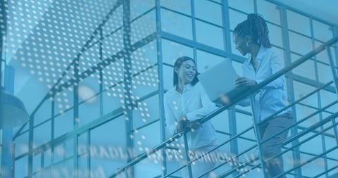 Diverse Team Discussing Financial Data Insights Using Laptop