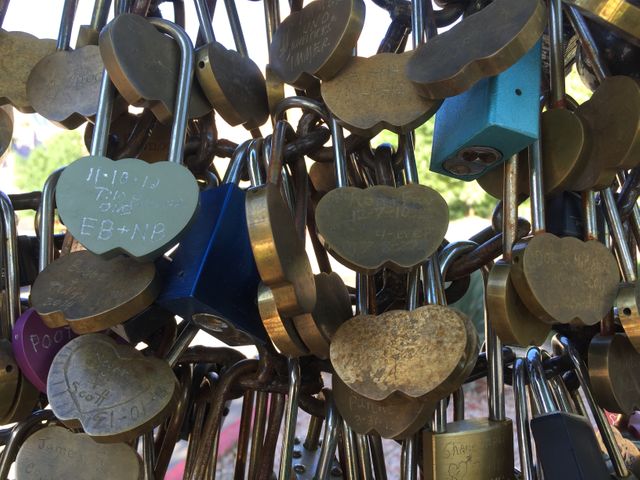 Perfect for illustrating concepts of love and commitment. Useful for romantic and wedding themes, relationship advice articles, or travel blogs featuring iconic love lock bridges. Highlights heartfelt symbols and personal engagements.