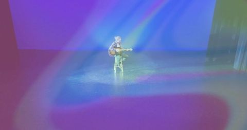 Solo Acoustic Guitar Performer on Dimly Lit Stage