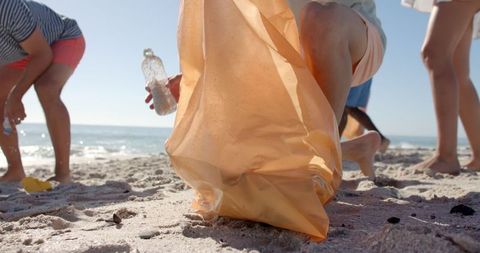Eco-Conscious Volunteers Conducting Beach Cleanup