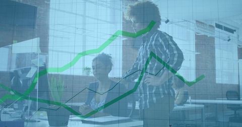 Office Team Evaluating Data Analysis on Computer Screen