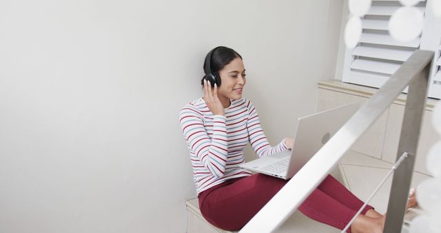 Young Woman Working from Home, Listening to Music on Headphones - Download Free Stock Images Pikwizard.com