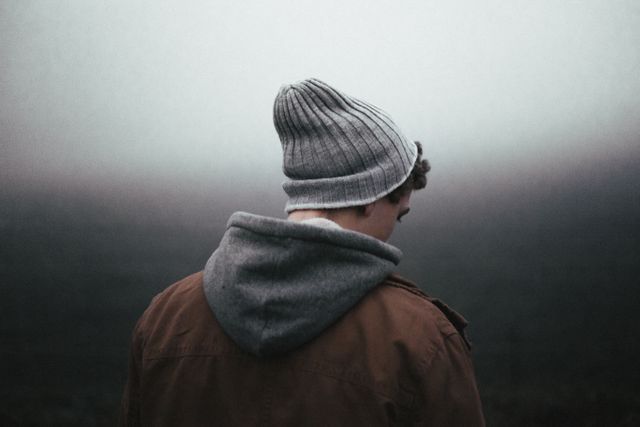 Solitary Person Wearing Hoodie and Beanie in Foggy Landscape - Download Free Stock Photos Pikwizard.com