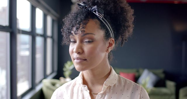 Confident Black Woman with Curly Hair in Modern Office - Download Free Stock Images Pikwizard.com