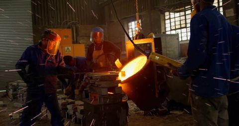Molten metal pouring in industrial foundry workshop