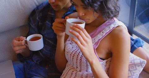 Couple Relaxing Together Drinking Warm Beverages in Cozy Atmosphere - Download Free Stock Images Pikwizard.com