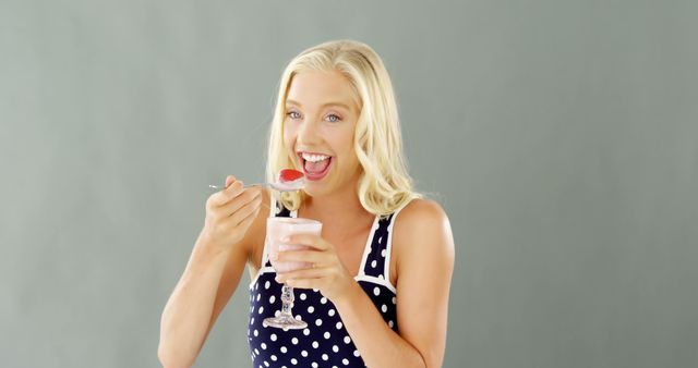 Smiling Blonde Woman Eating Strawberry Yogurt - Download Free Stock Images Pikwizard.com