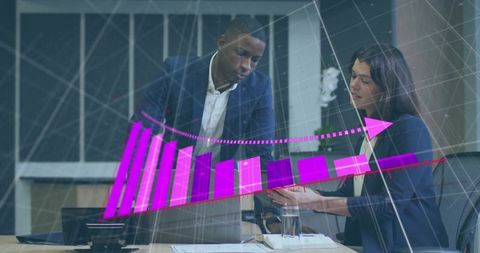 Colleagues collaborating on tablet and laptop displaying holographic growth bar chart