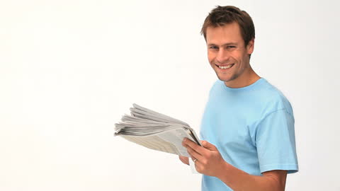 Smiling Man Reading Newspaper in Light Shirt