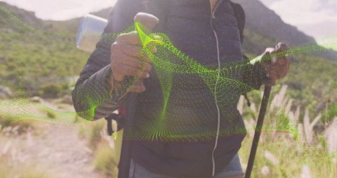 Hiker with Trekking Poles on Rocky Trail in Wilderness