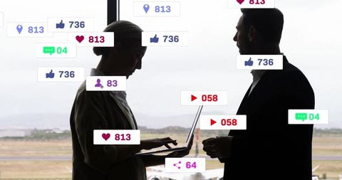 Business Colleagues Engaging with Technology at Airport Window