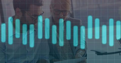 Colleagues analyzing data overlaid with bar graph visualization