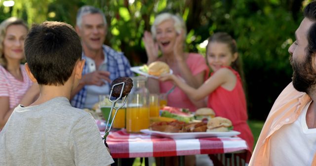 Family Enjoying Outdoor Barbecue Picnic in Garden - Download Free Stock Images Pikwizard.com