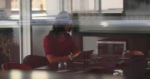 Businesswoman Engaging with Tablet in Modern Conference Room