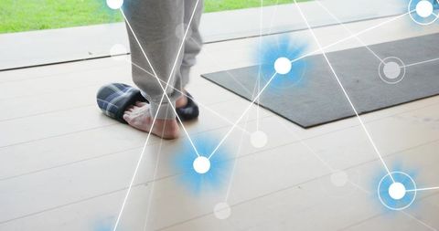 Senior stepping into plaid slipper by glass door, yoga mat and digital wellness overlay