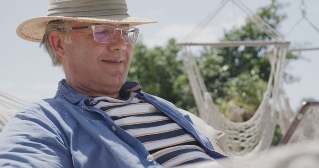 Relaxed Senior Man with Hat Enjoying Outdoor Leisure - Download Free Stock Images Pikwizard.com