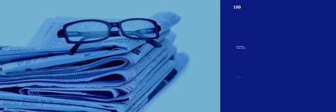 Stack of Newspapers Topped with Glasses Reflecting Current Trends Concept