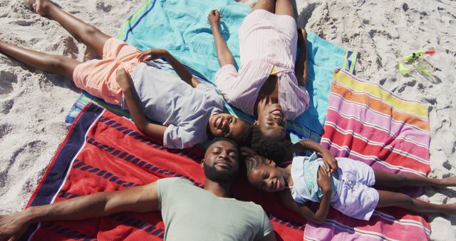 Family enjoying sunny day relaxing on beach towels - Download Free Stock Images Pikwizard.com