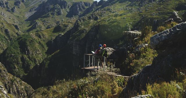 Caucasian couple wearing helmets and trekking in mountains - Download Free Stock Photos Pikwizard.com