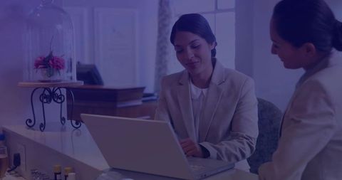 Professional Businesswomen Collaborating at Reception Desk