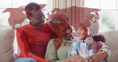 Multigenerational Black family embracing on light sofa with red world map overlay