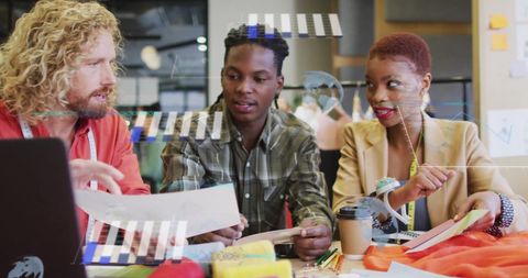 Diverse Business Team Collaborating in Modern Office with Financial Graphics