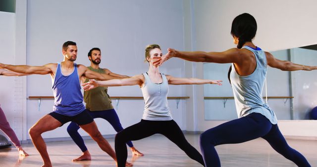 Group Practicing Warrior Pose in Yoga Studio - Download Free Stock Images Pikwizard.com