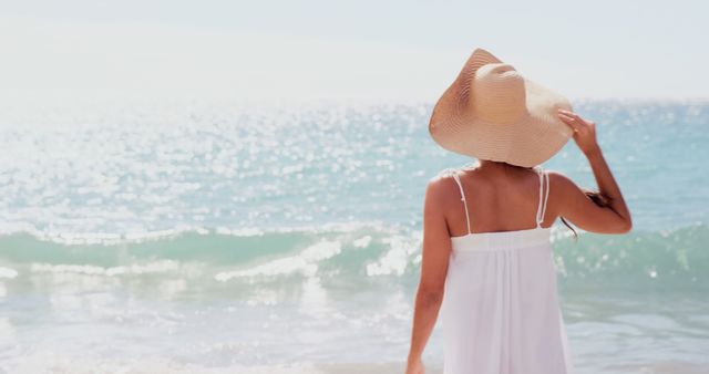 Woman Relaxing at Beach in Sun Hat and White Dress - Download Free Stock Images Pikwizard.com