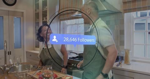 Middle-aged couple cooking together in bright kitchen celebrating 28,646 social followers