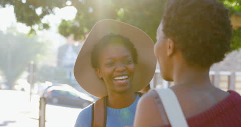 Joyful Twins Sharing a Moment in Urban Setting with Sunlight