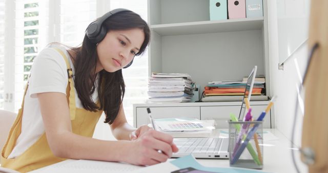 Young Student with Headphones Studying at Home Workspace - Download Free Stock Images Pikwizard.com