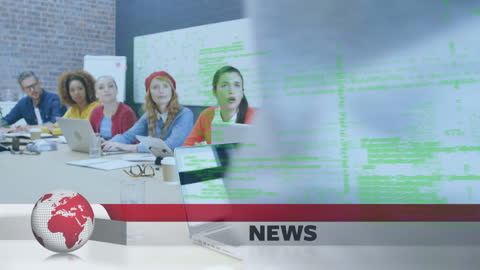 Diverse Team in Office Analyzing Data on Laptops