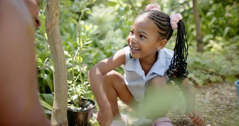 Happy Girl Enjoying Gardening Among Greenery