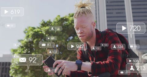 Man with Smartphone Interacting with Real-Time Social Media Analytics