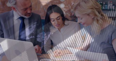 Professional team analyzing documents in modern lounge