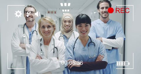 Diverse doctors smiling in hospital corridor film reel