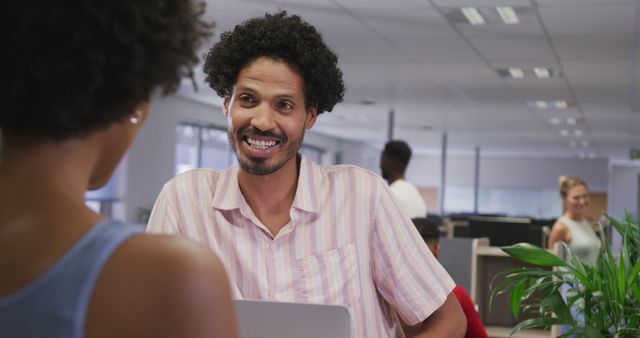 Smiling Businessman Interacting with Colleague in Modern Office - Download Free Stock Images Pikwizard.com