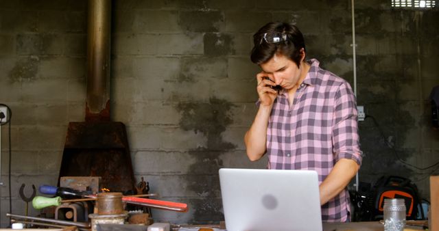 Young Male Engineer Working on Laptop in Industrial Workshop - Download Free Stock Images Pikwizard.com