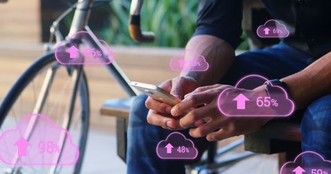 Man using smartphone surrounded by digital cloud upload icons