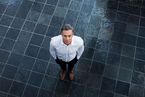 Elegant professional standing on slate flooring