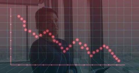 Businesswoman Reviewing Declining Graph in Modern Office