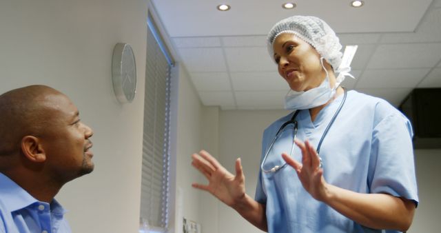 Doctor in Surgical Attire Talking with Patient in Hospital Room - Download Free Stock Images Pikwizard.com