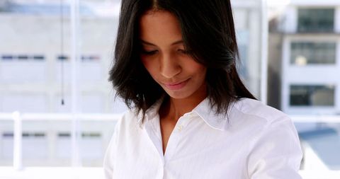 Businesswoman Engaged with Smart Watch in Modern Office - Download Free Stock Images Pikwizard.com