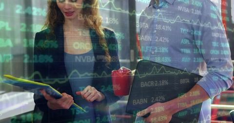 Business colleagues reviewing financial data with laptop, folder and stock chart overlay